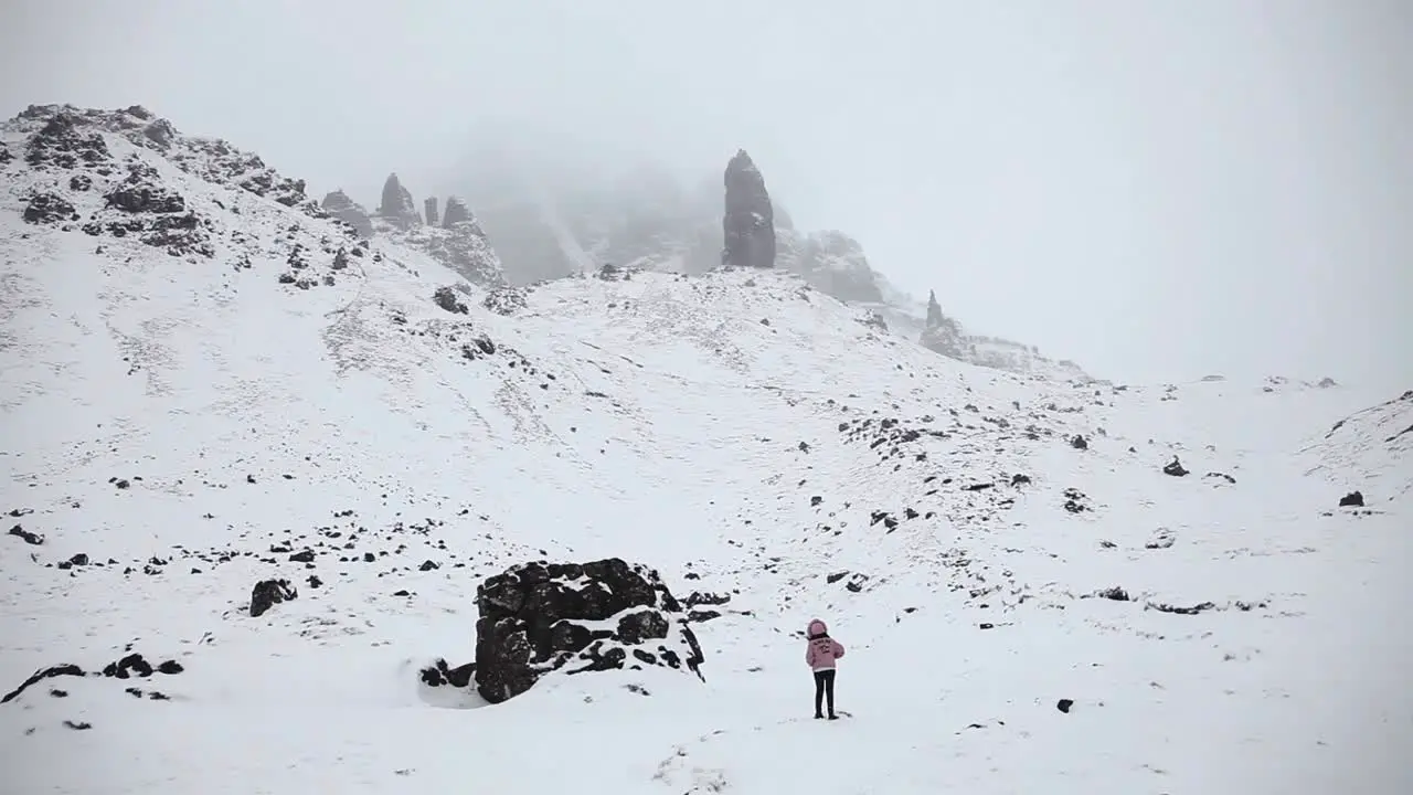 Adventurer looking around winter scene highlands Scotland panoramic shot wide angle