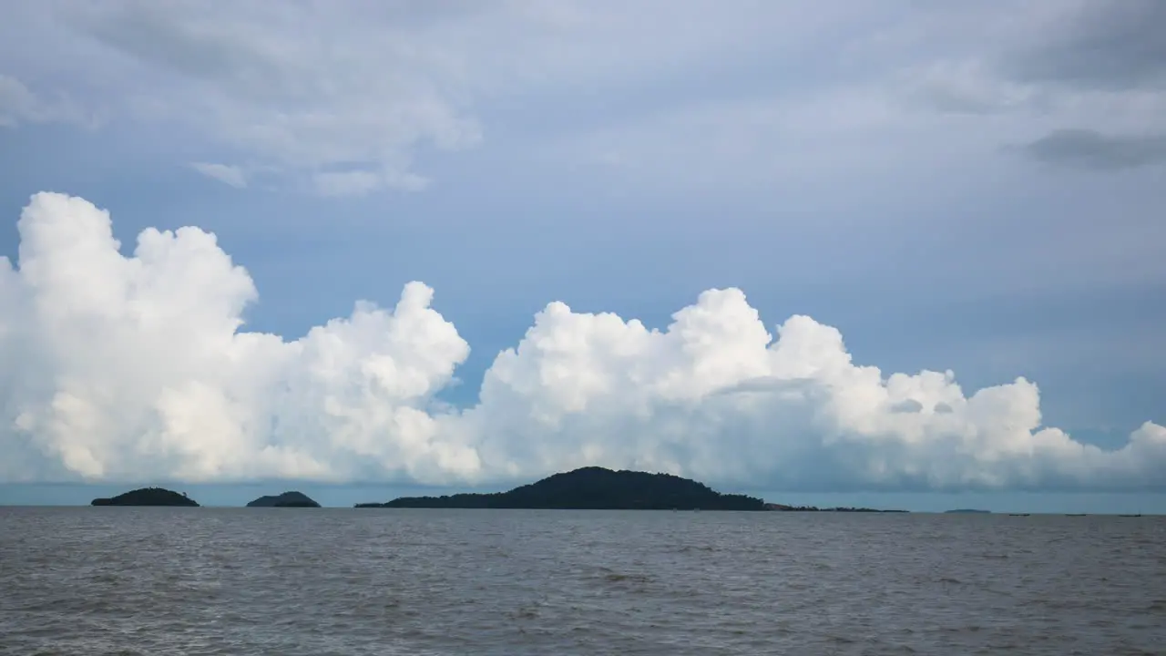 Storm clouds bubbling up over land at sea