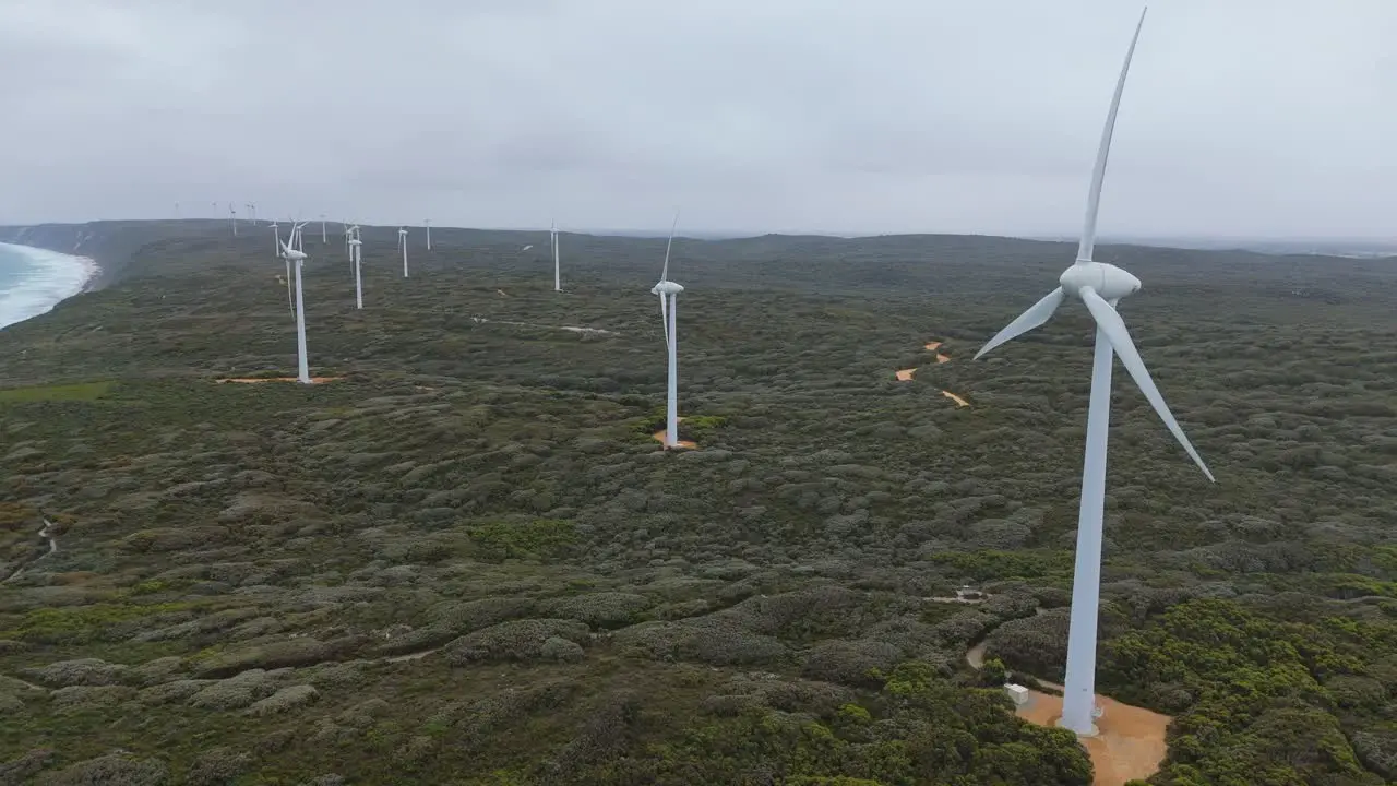 Drone flying away from Albany wind farm on cloudy day