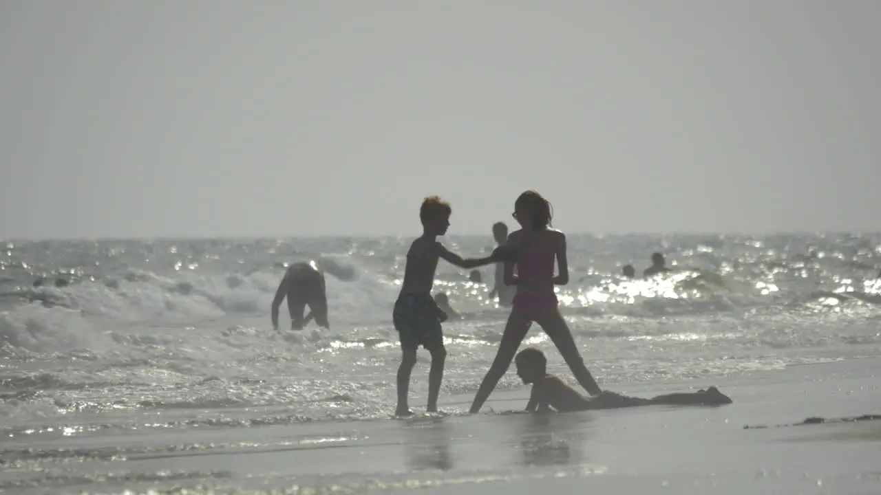 Gran Canaria island Spain view of children swimming in the stormy Atlantic Ocean