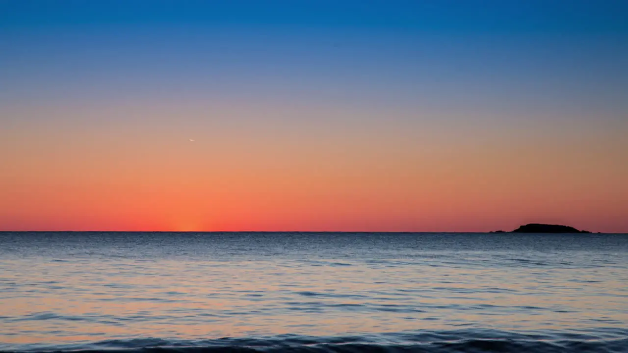 Time-lapse of the sunrise next to an island in Lake Superior