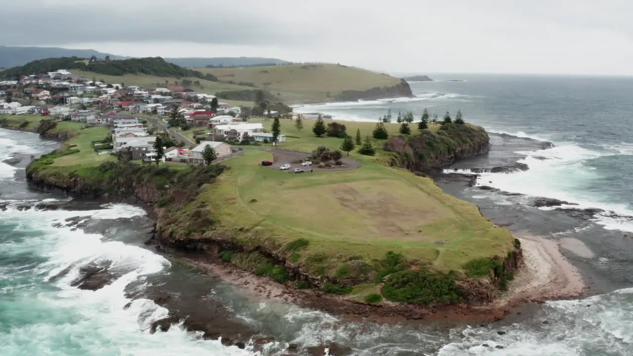 Aerial drone shot over the ocean and rocks of Gerroa headland on a stormy day in south coast NSW Australia