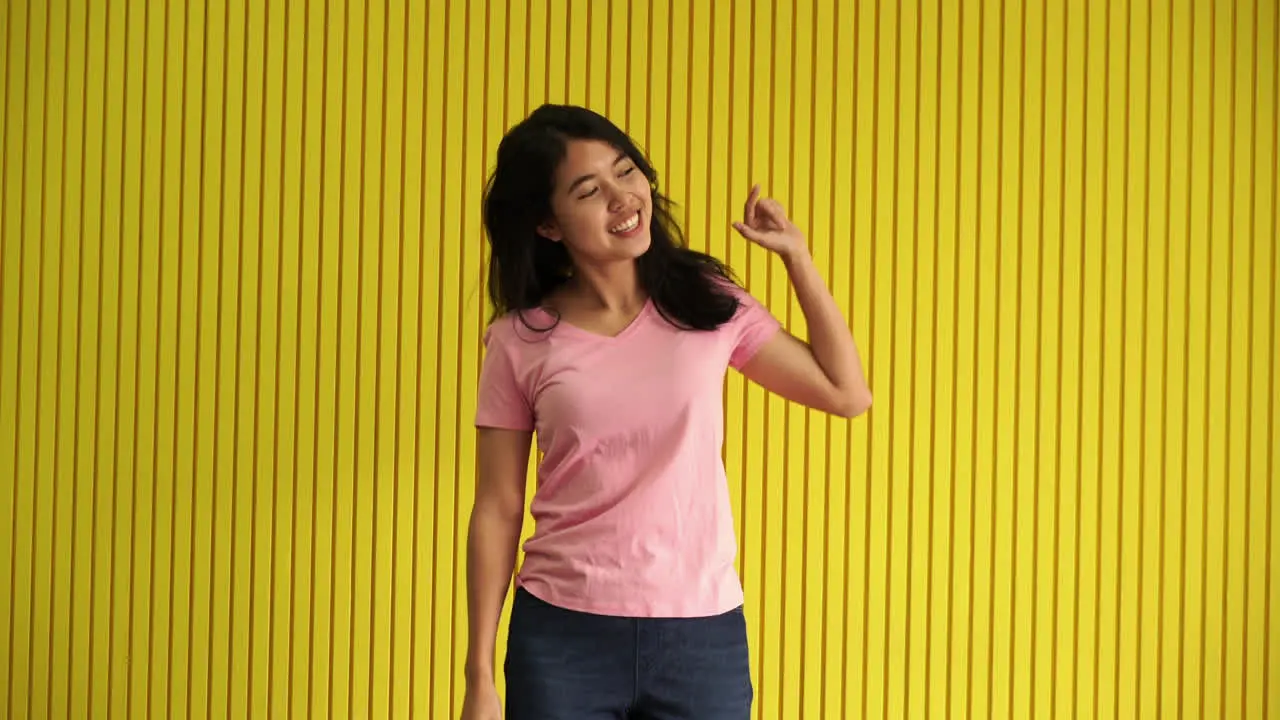 Asian Women dancing with yellow background