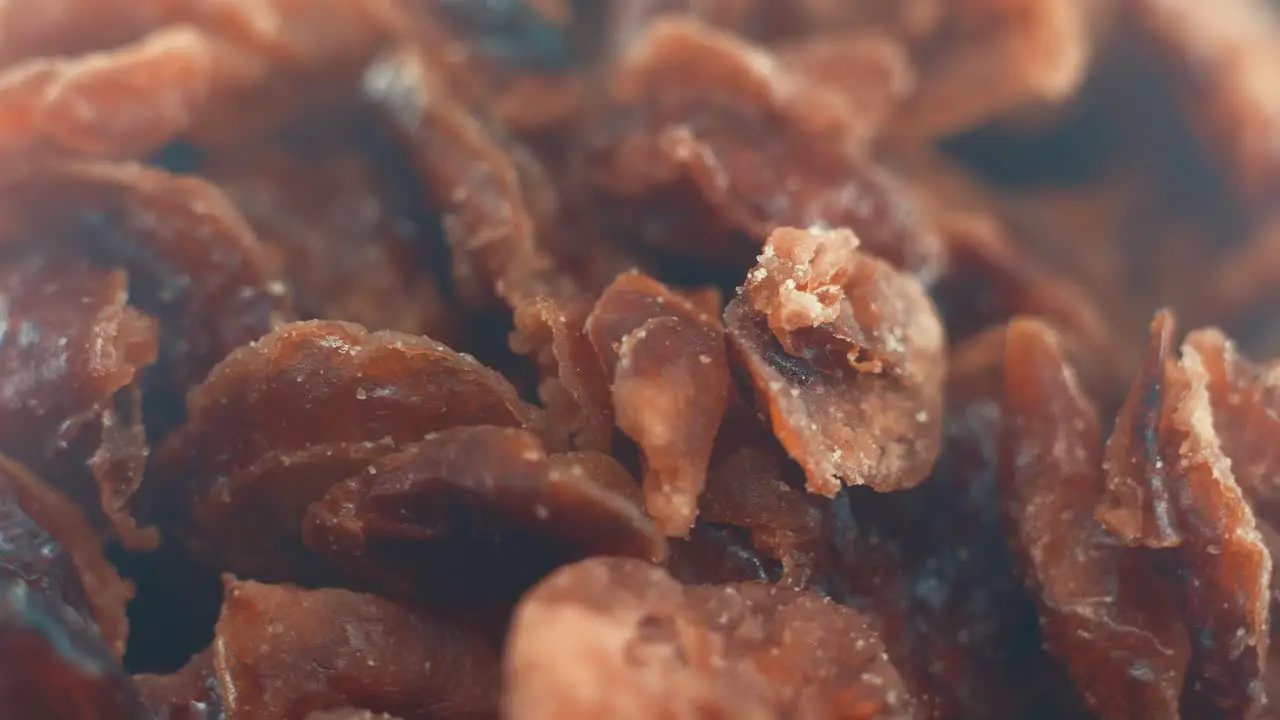 A macro close up shot of a pile of dry cranberry in a bawl on a rotating stand slow motion 4k