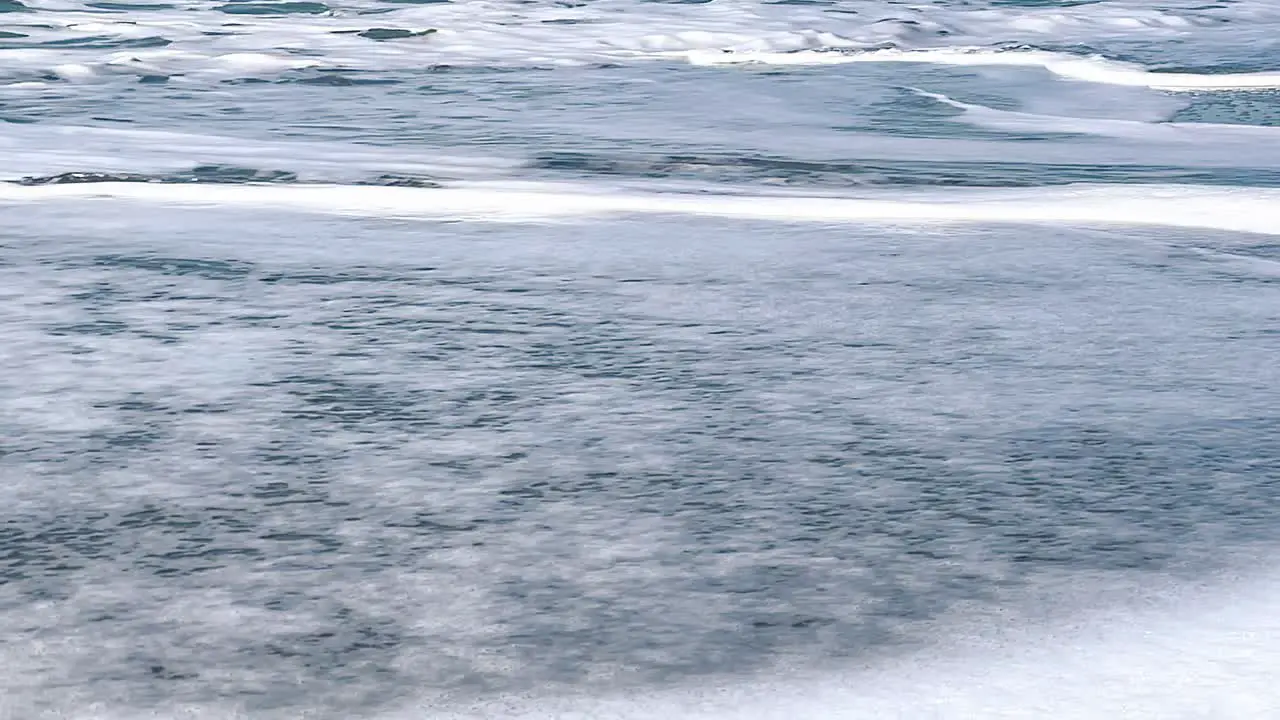 View of beautiful sea waves on the beach Aerial view of ocean shoreline deep blue ocean water and foamy waves