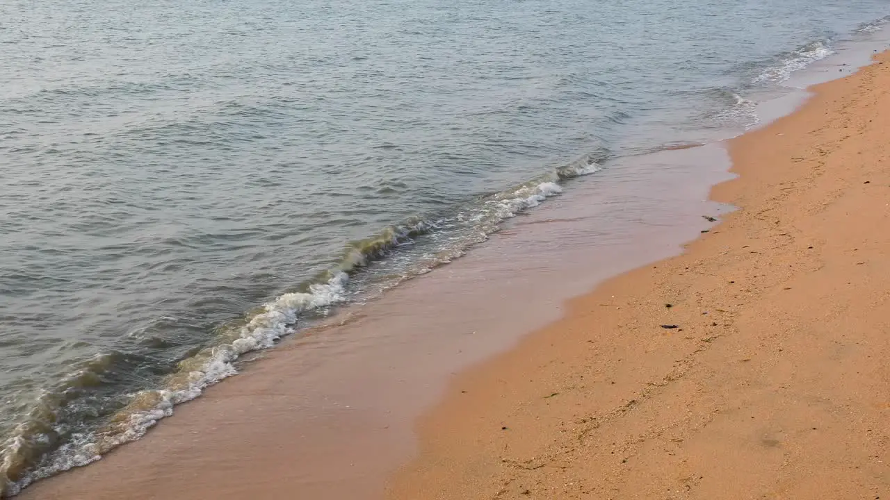 Ocean Waves Along the Sandy Shores of Bangsaray in Pattaya Thailand