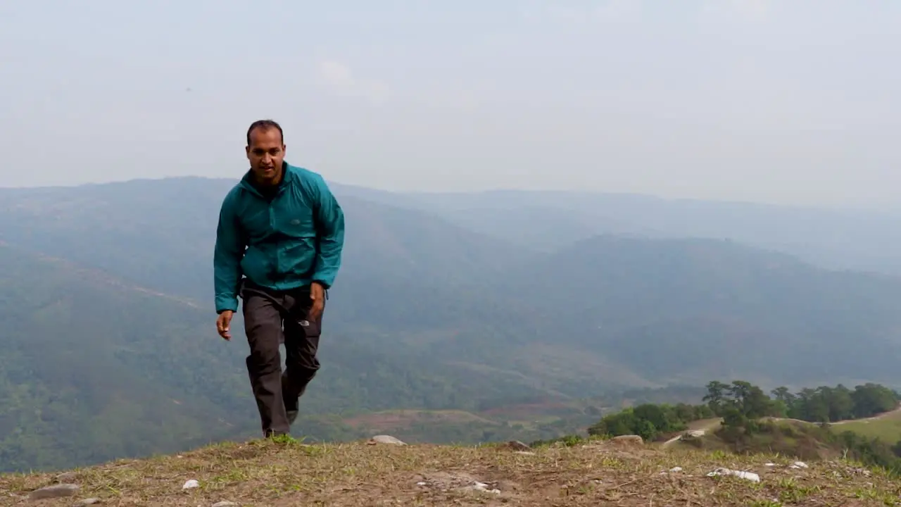 man running on mountain top with misty mountain rage background from flat angle video is taken at nongjrong meghalaya india