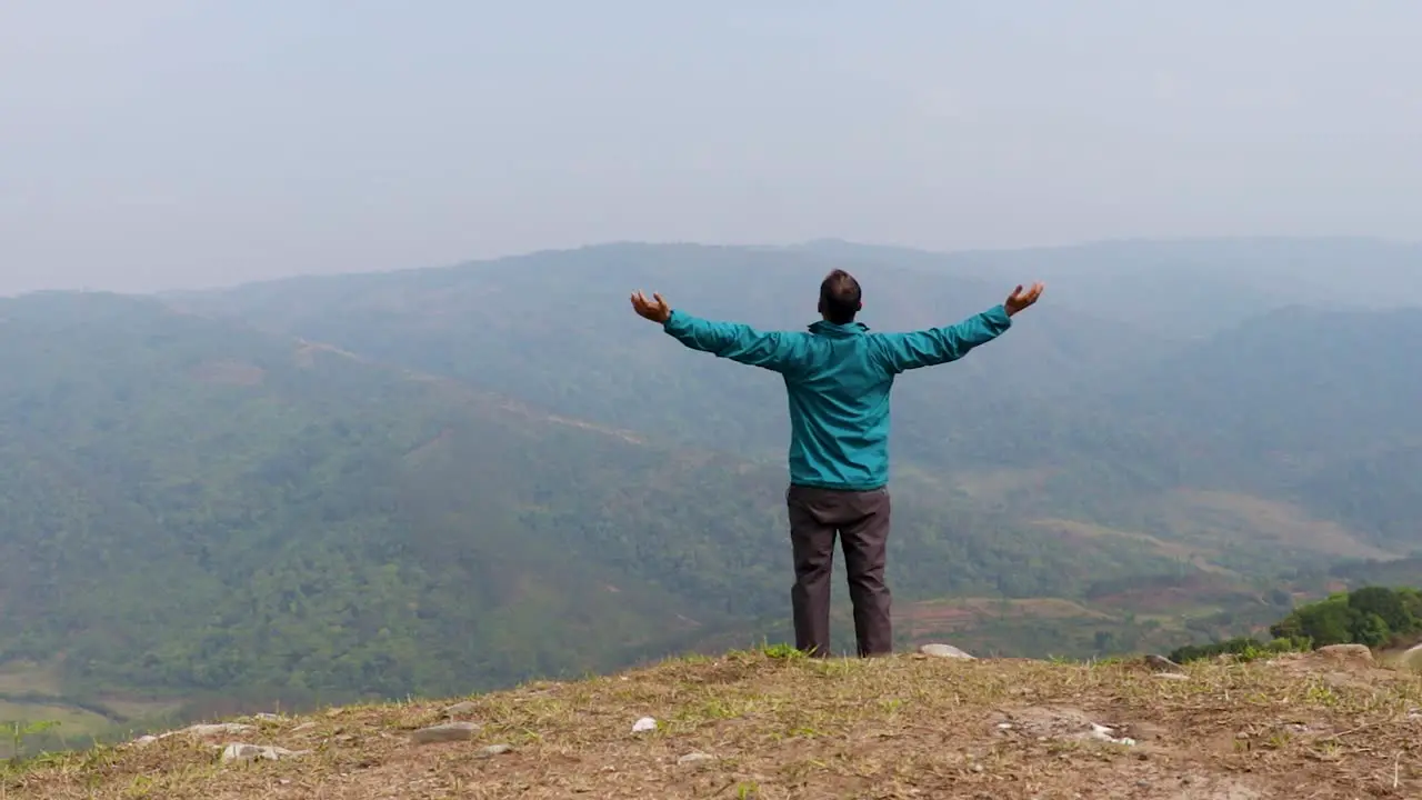 man walking alone at hill top with misty mountain rage background from flat angle video is taken at nongjrong meghalaya india