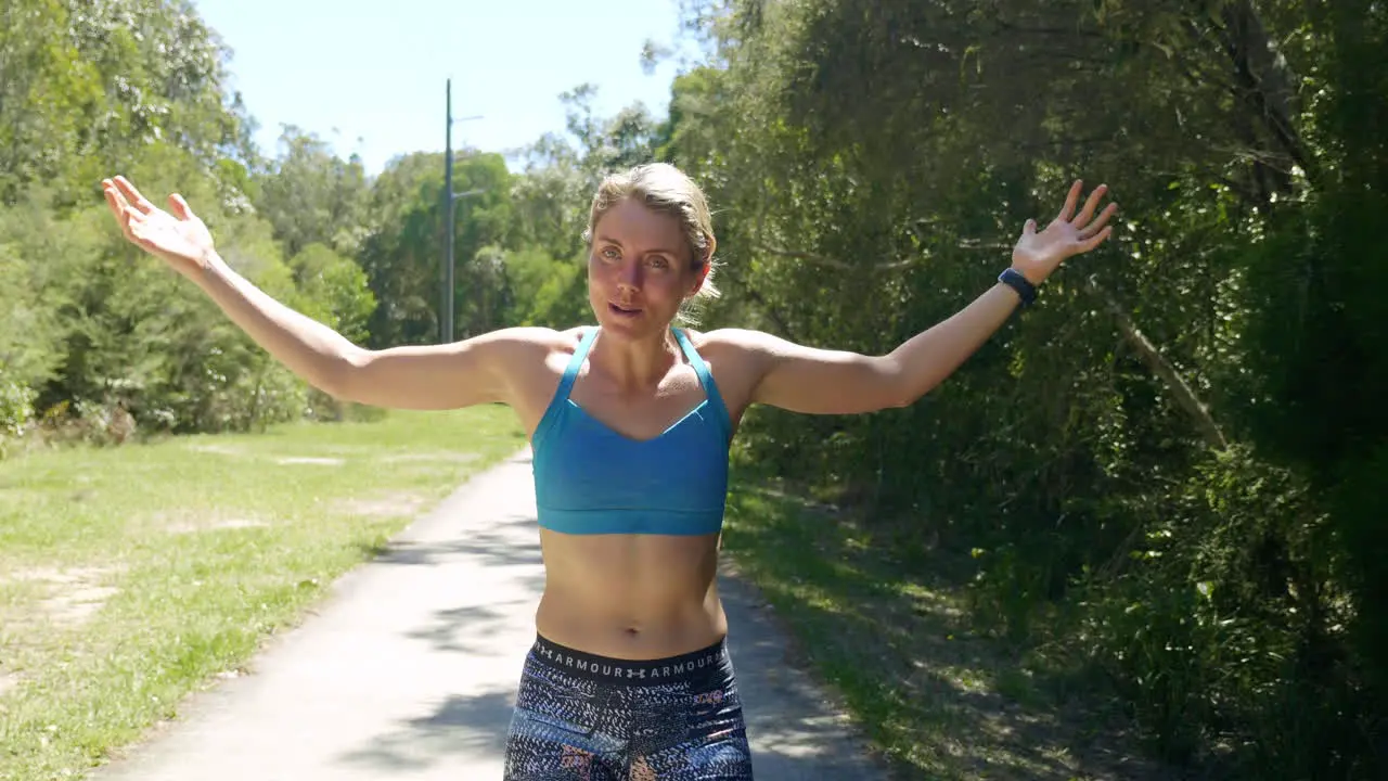 Fit Muscular Blonde Female Athlete Happily Raising Arms Celebrating Race 4K Slow Motion