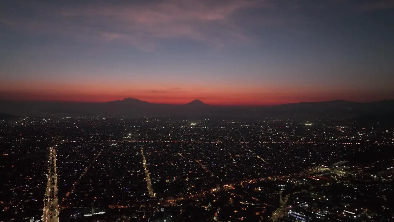 Calm Serene Sunset and Nightfall over Mexico City Lights Aerial Drone