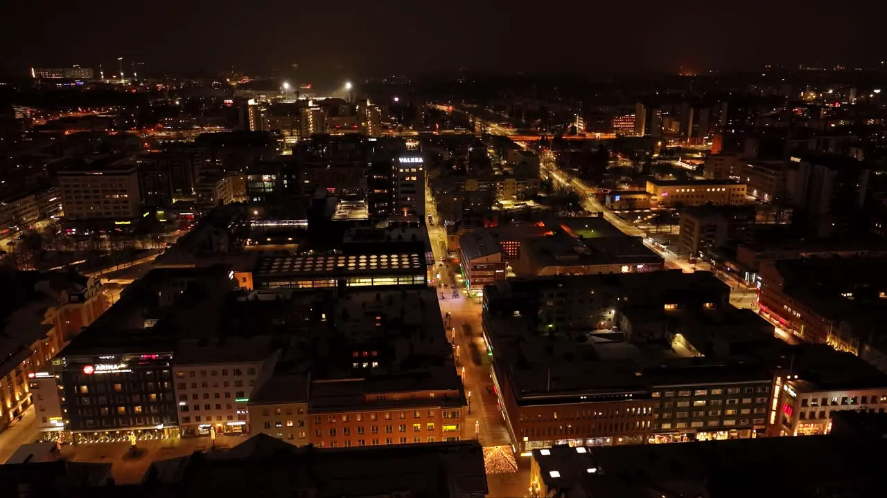 Illuminated city streets of downtown Oulu winter night in Ostrobothnia Finland Aerial view