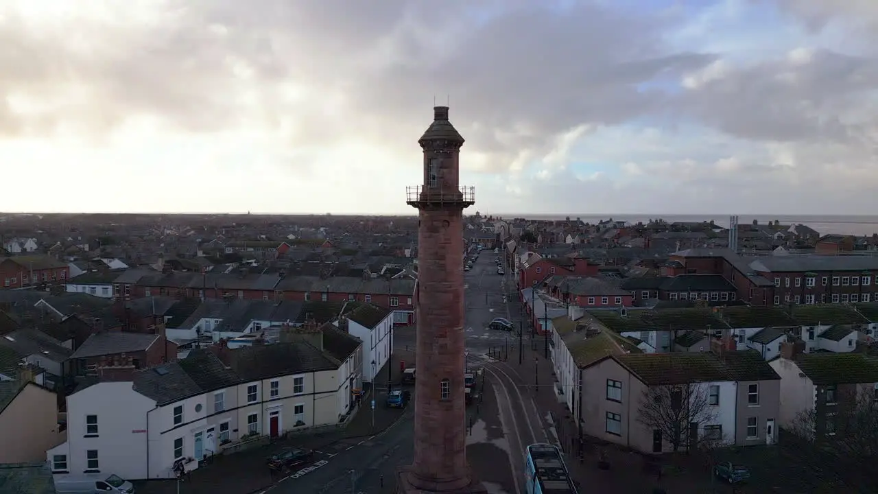 Inland lighthouse amongst urban setting at the port of Fleetwood with tram leaving