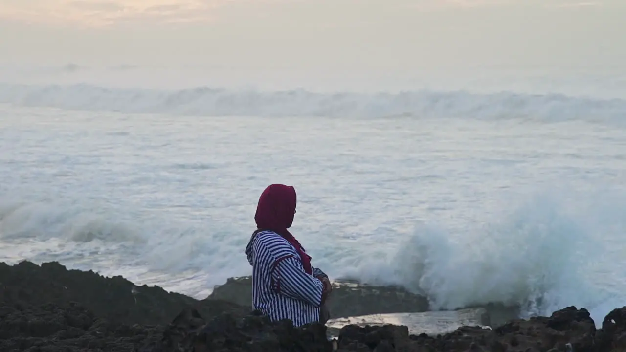 Moroccan woman watching the waves in Casablanca Morocco