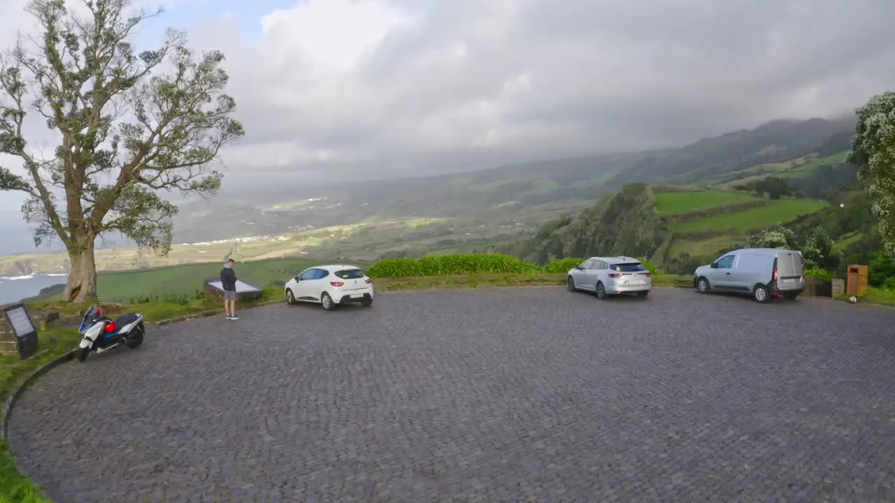 Parking lot lookout with cars above Azores coast cliffs after storm