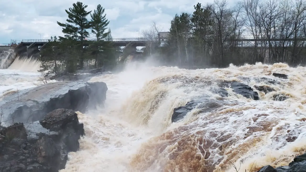 High spring floodwaters surround a local dam