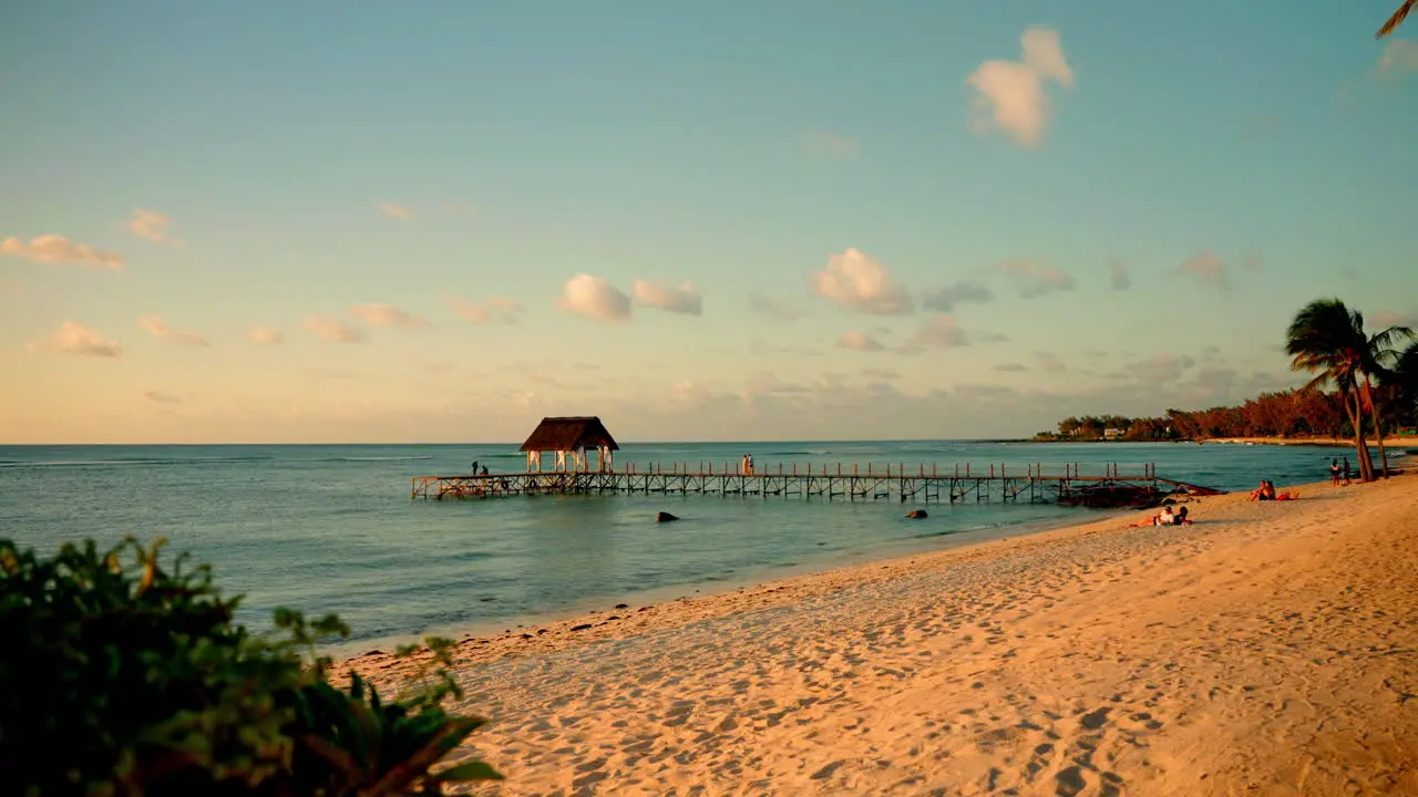 Static wide shot of beautiful tropical empty beach at sunset