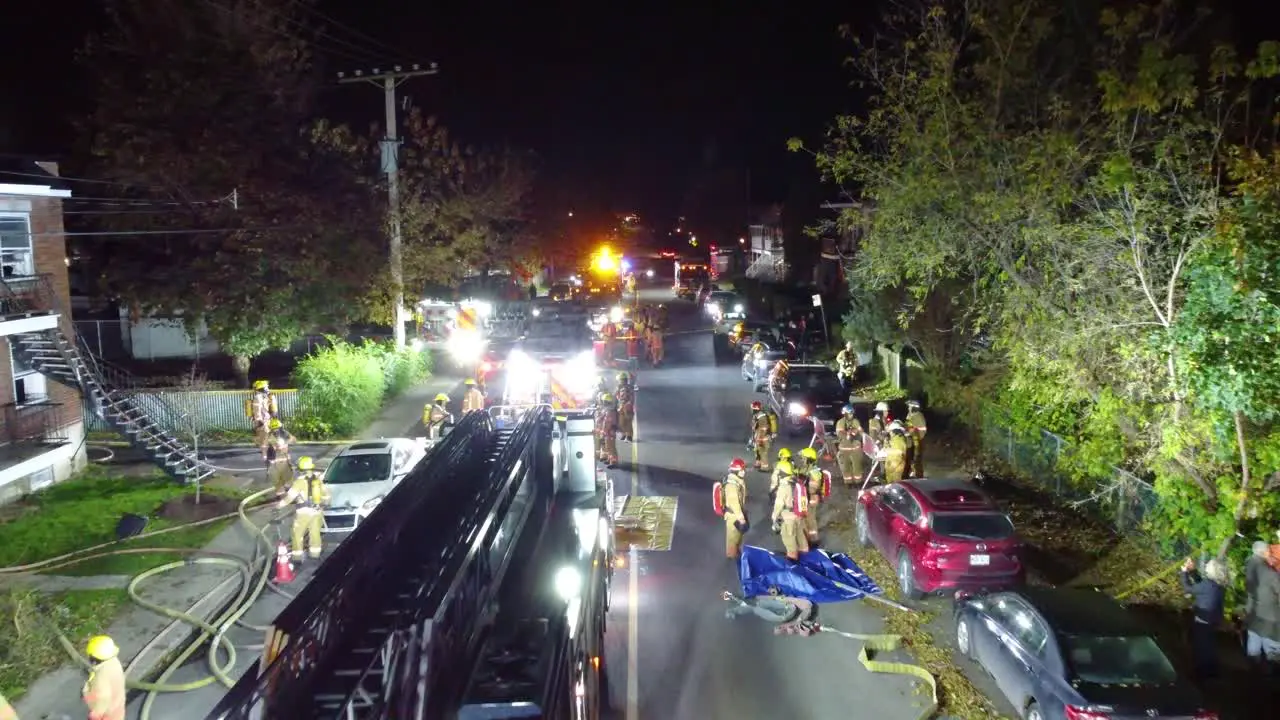 Aerial Drone Fly Above Firefighters Truck and Workers in Uniform at Night Canada Montreal City