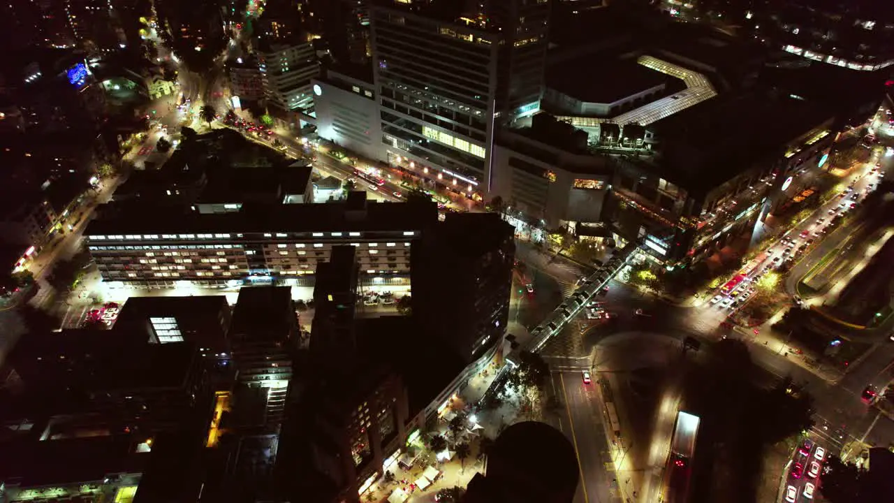 Aerial orbit shot around Los Leones at night Las Condes district