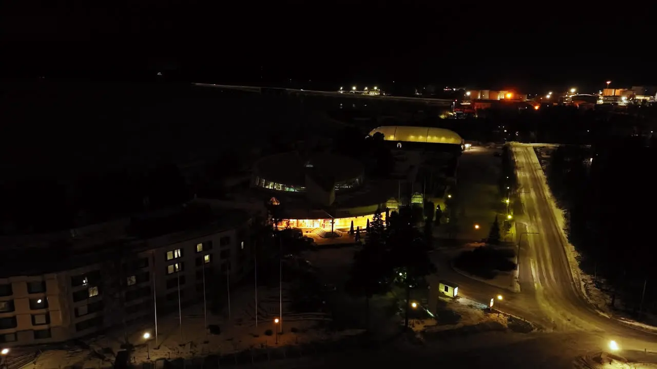 Aerial view orbiting the illuminated Tropiclandia aquapark in Vaasa Finland