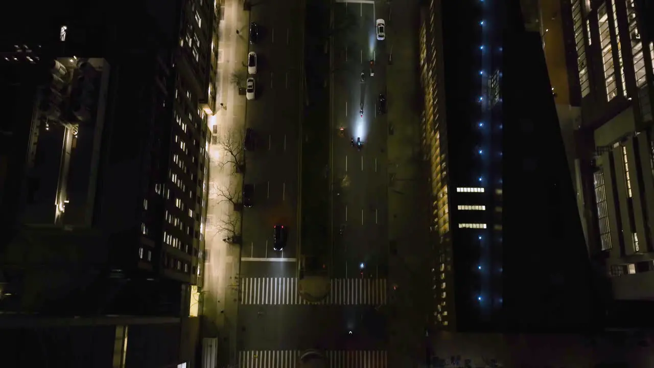 Aerial view following motorcycles on the night lit street of New York USA