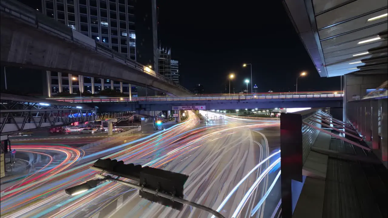 Long exposure night lapse of a busy intersection at Thai Japanese bridge in Bangkok Thailand