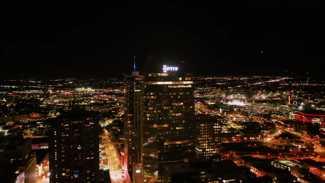 Aerial tracking shot of the illuminated cityscape in Denver night in Colorado USA