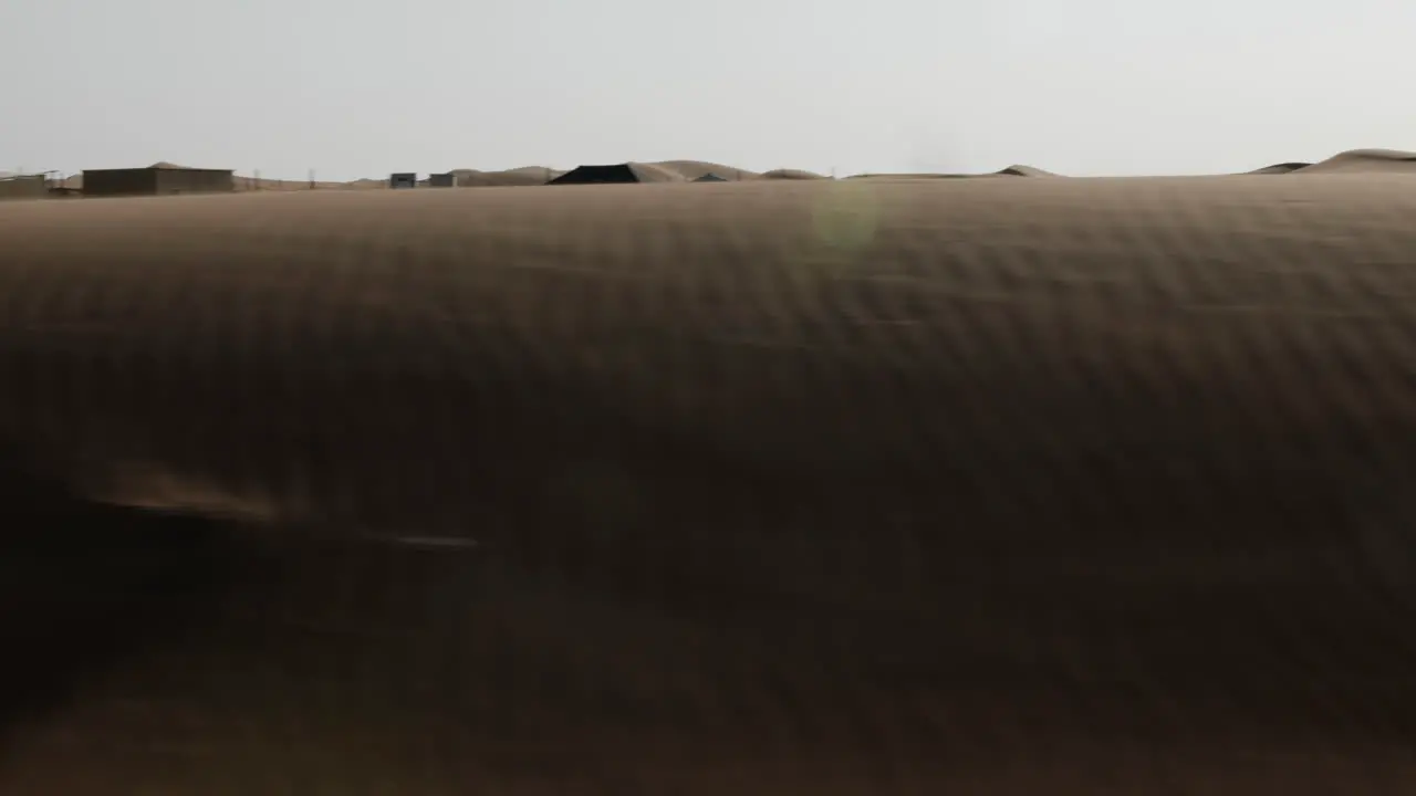 Driving through a middle eastern desert landscape on road near Dubai in United Arab Emirates in sunset