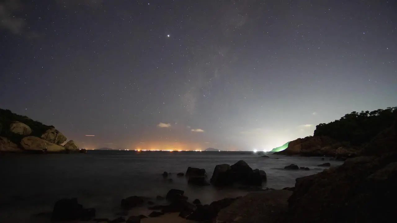 Cheung Chau active harbour lights glowing underneath fast night sky clouds timelapse