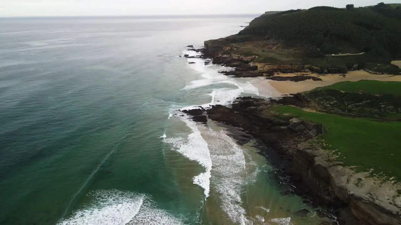 Cantabrian sea cliff shoreline Spain aerial of waves crashing on rocks