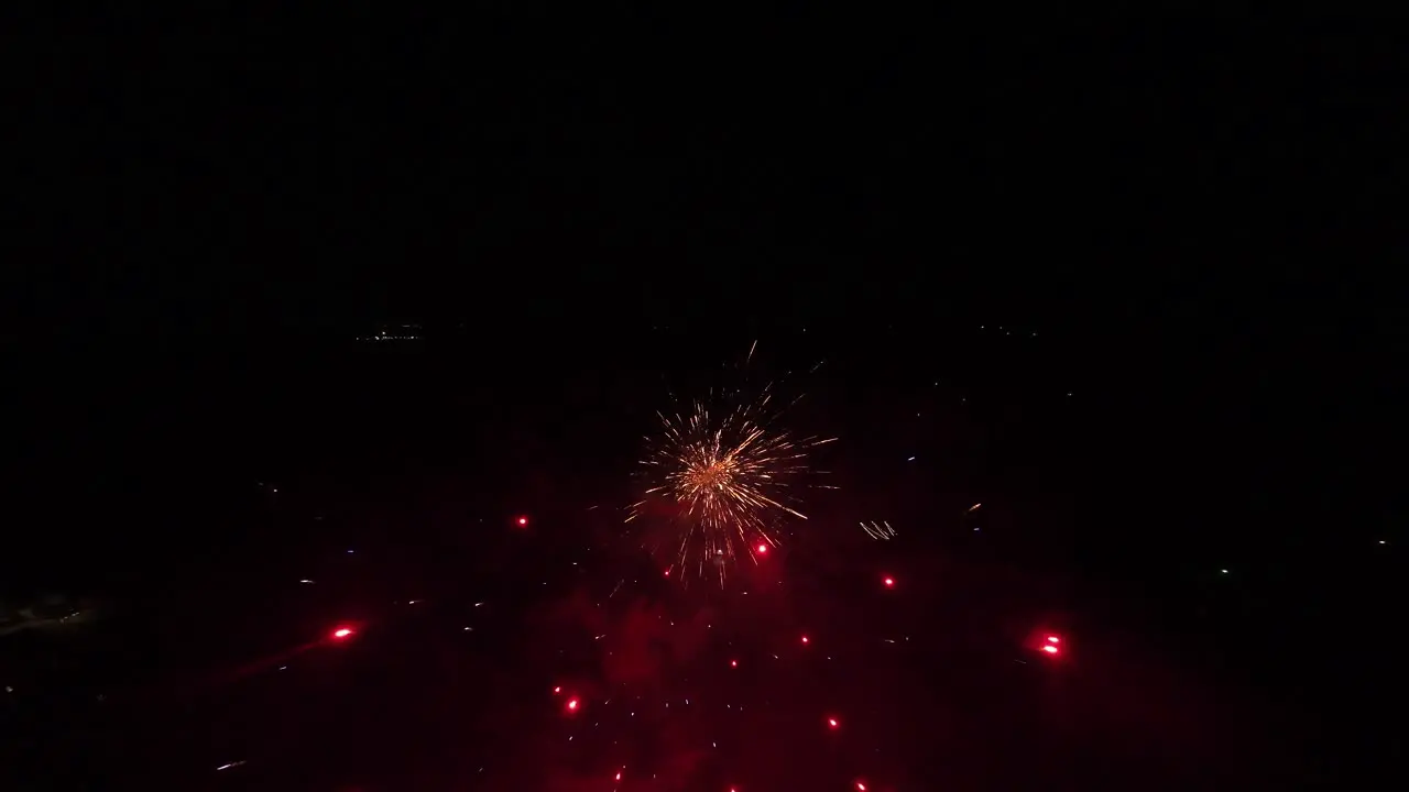 Fireworks of different colors being launched in the dead of night