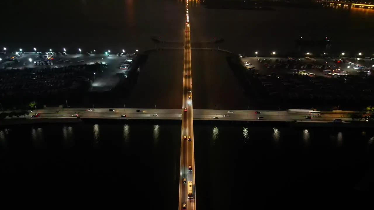 Tilt up aerial view over bridge revealing Taipa Macau