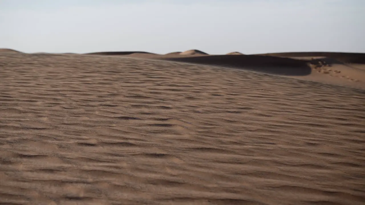 Slow motion sand blowing in a desert