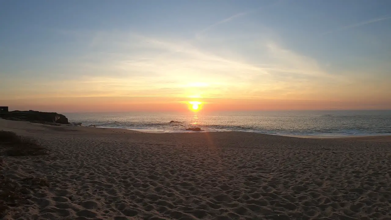 Calm ocean waves sound under warm sunset in Portuguese beach