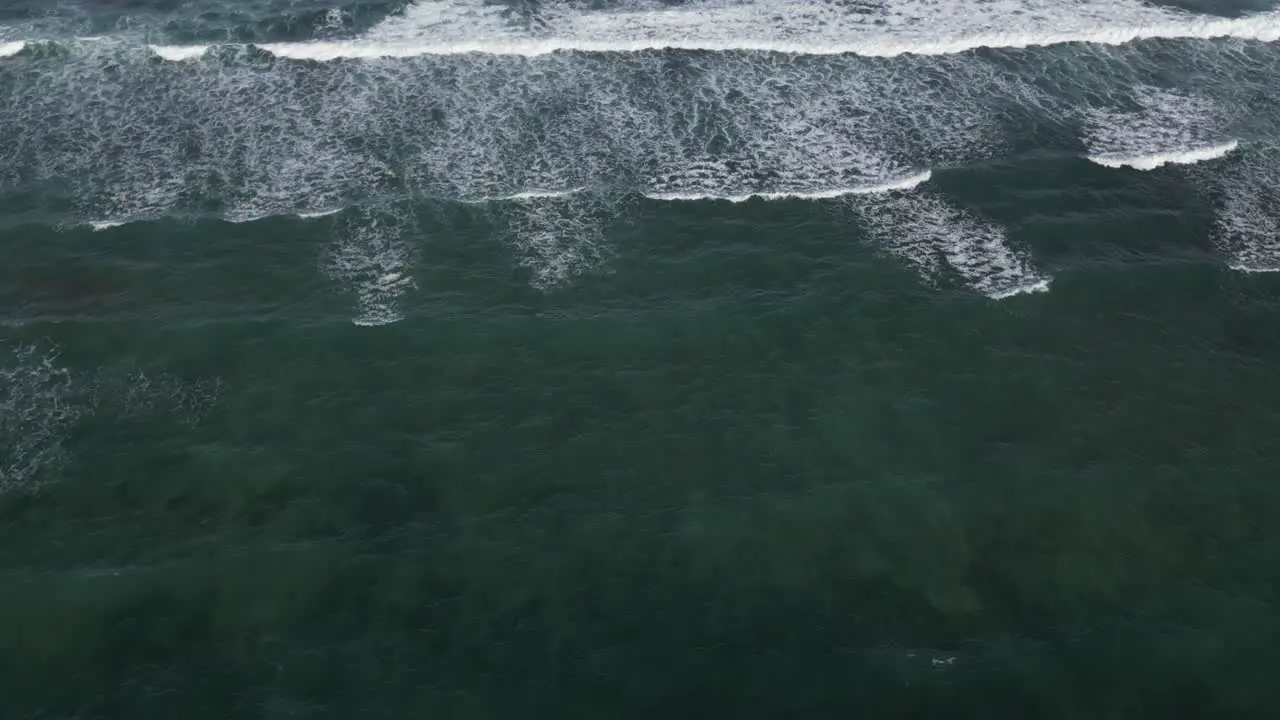 Slow zoom onto rolling waves off the coast of Uluwatu in the South of Bali Indonesia