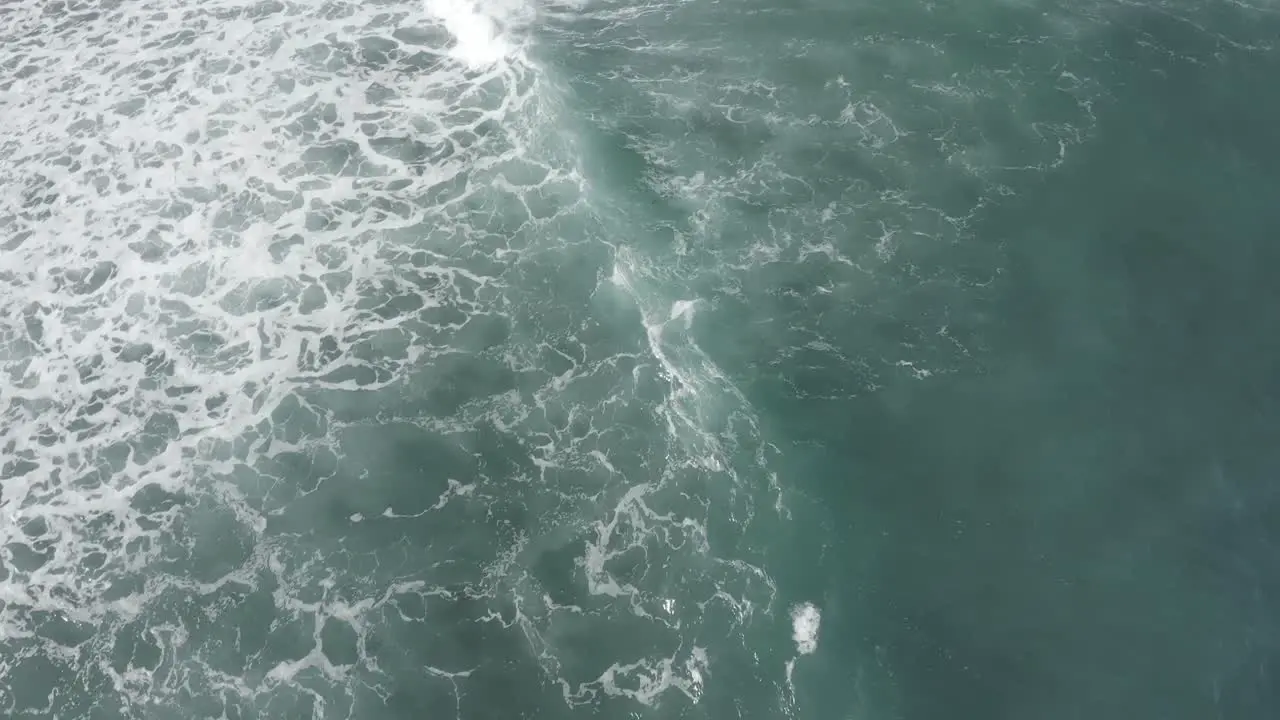 Waves breaking on a reef with camera panning with wave