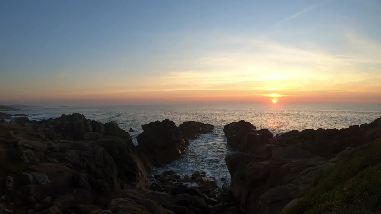 Calm ocean waves sound under warm sunset in Portuguese rocky beach