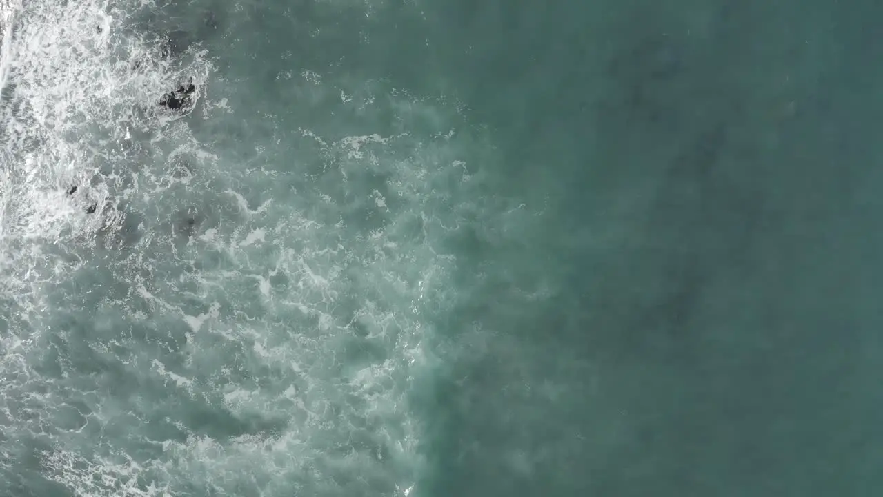 top down view as waves breaks on reef break