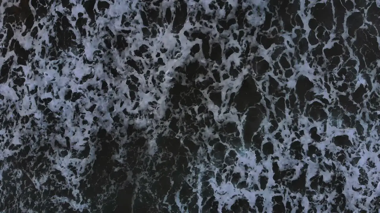 Top Down Aerial View of Ocean Waves Crashing