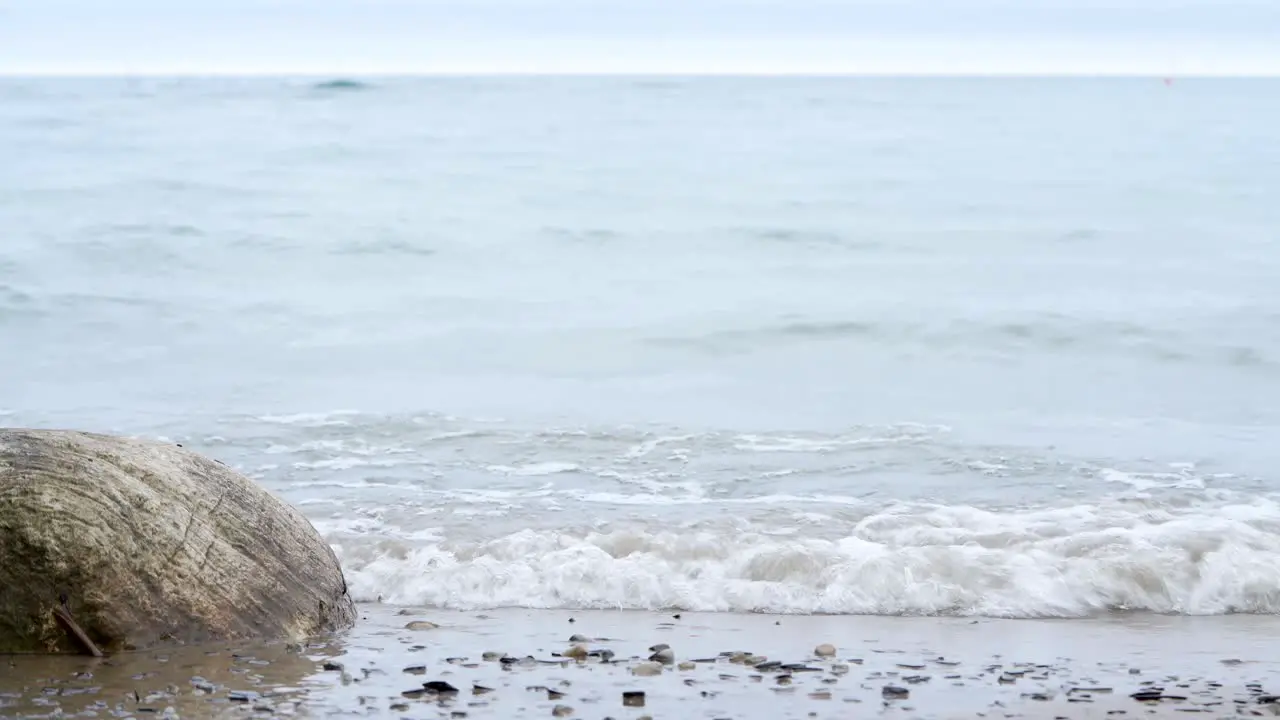 Small waves breaking on a big lake