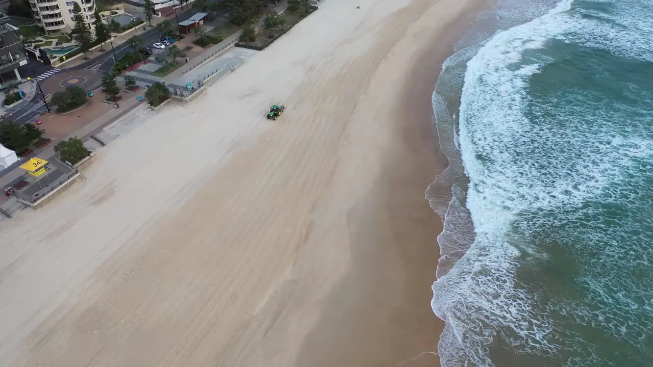 Tractor cleaning the beach sand at Surfers paradise