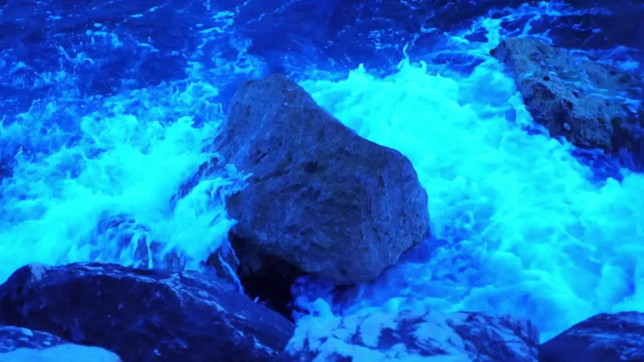 rocks on the coast of france with waves smashing in slow motion in the evening