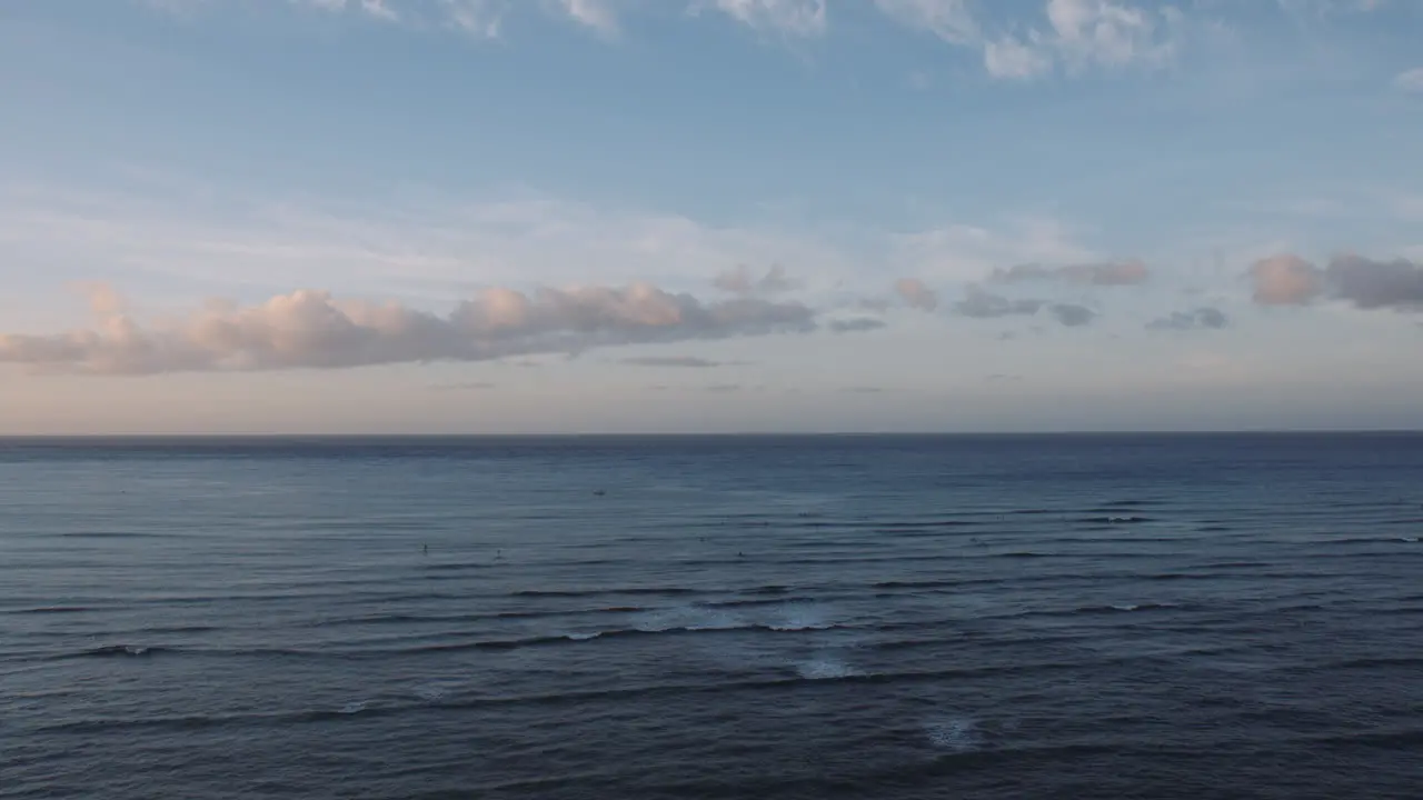 Early Morning Surfers Riding the Waves on Waikiki Bay Coastal Horizon and Colorful Sunrise Hawaii