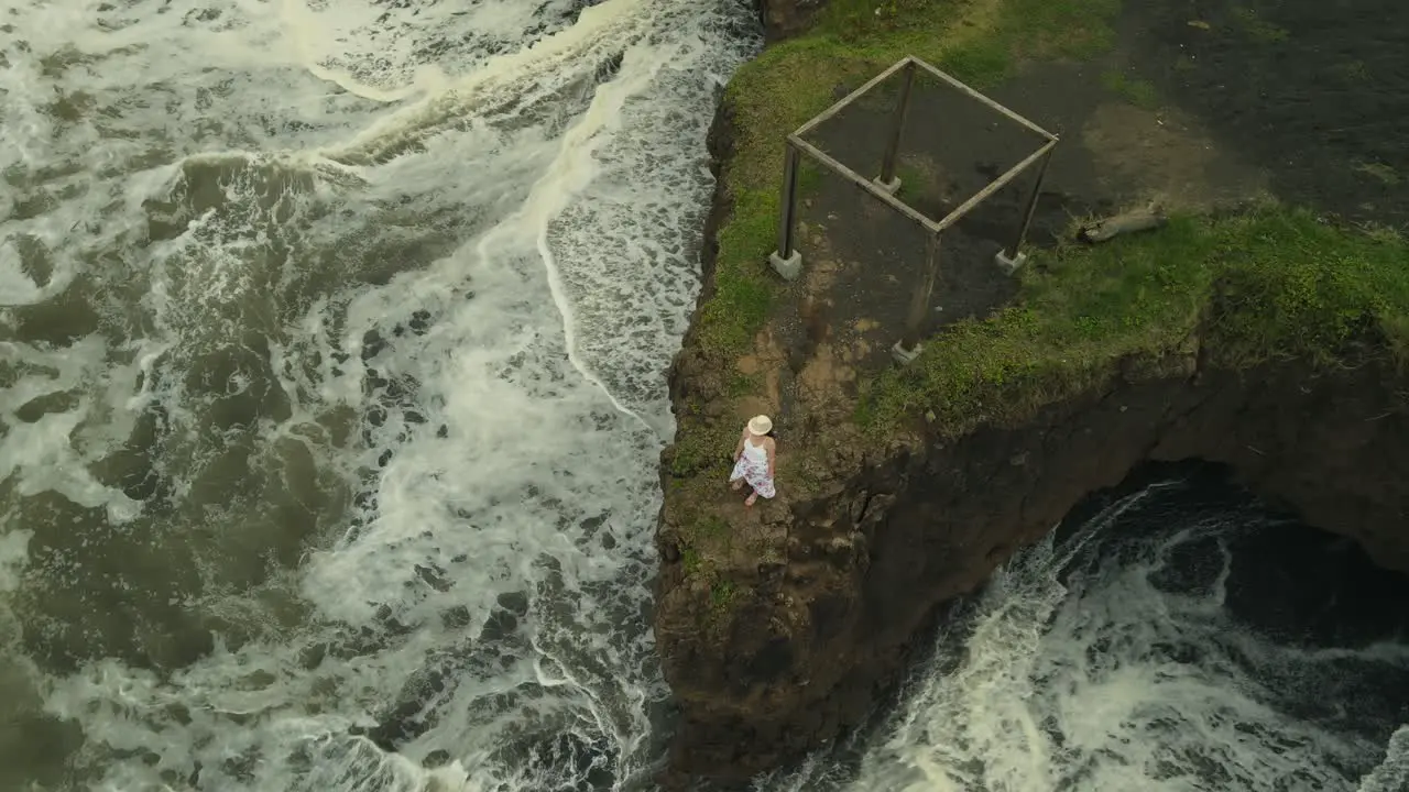 Aerial Drone Flyover Beautiful Woman On Beach Cliff Surrounded By Ocean Waves 4K Costa Rica