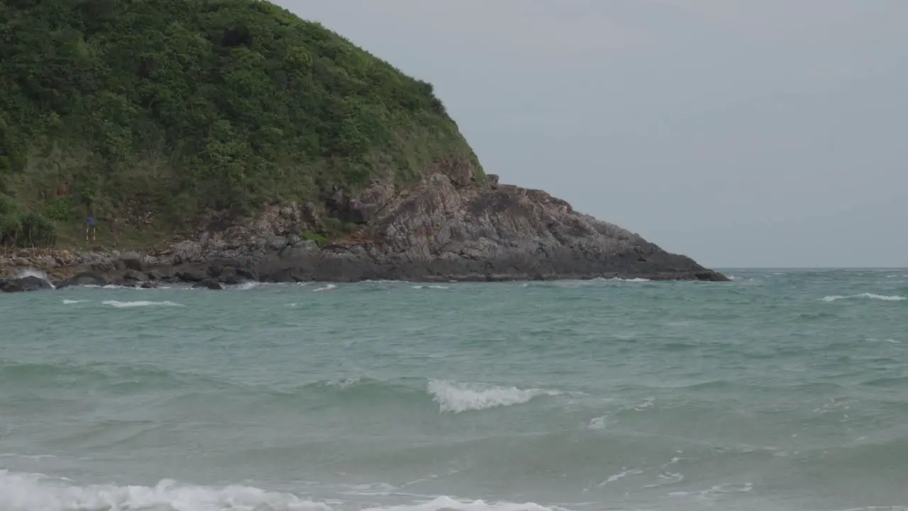 Tranquil Scenery Of Ocean Waves Near The Mountain Shore On A Breezy Day In Dam Trau Beach In Con Dao Vietnam