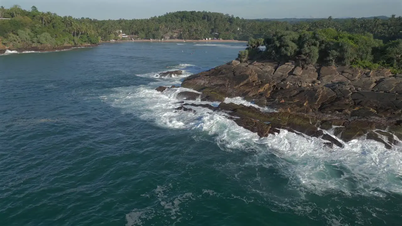 Establishing Aerial Drone Shot Revealing Hiriketiya Bay behind Headland in Southern Sri Lanka