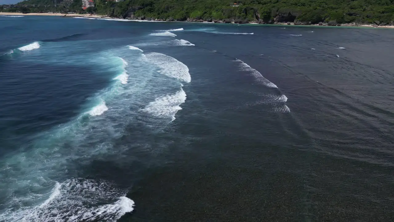 Coastal scenery with distant beaches and rolling waves in the foreground aerial