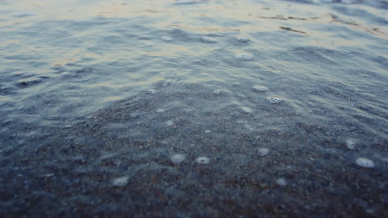 Blue ocean water waves splashing sandy beach in slow motion Abstract nature