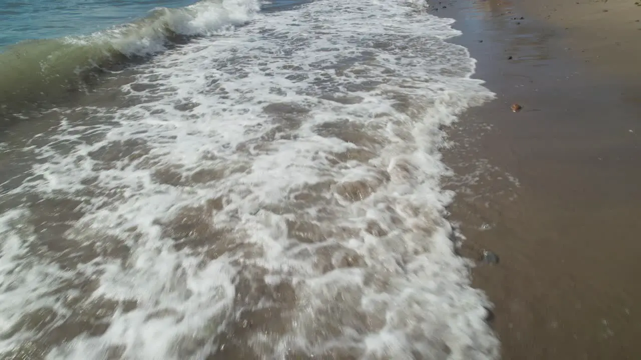 Ocean waves at the beach tilting up to the horizon level to reveal the coastline