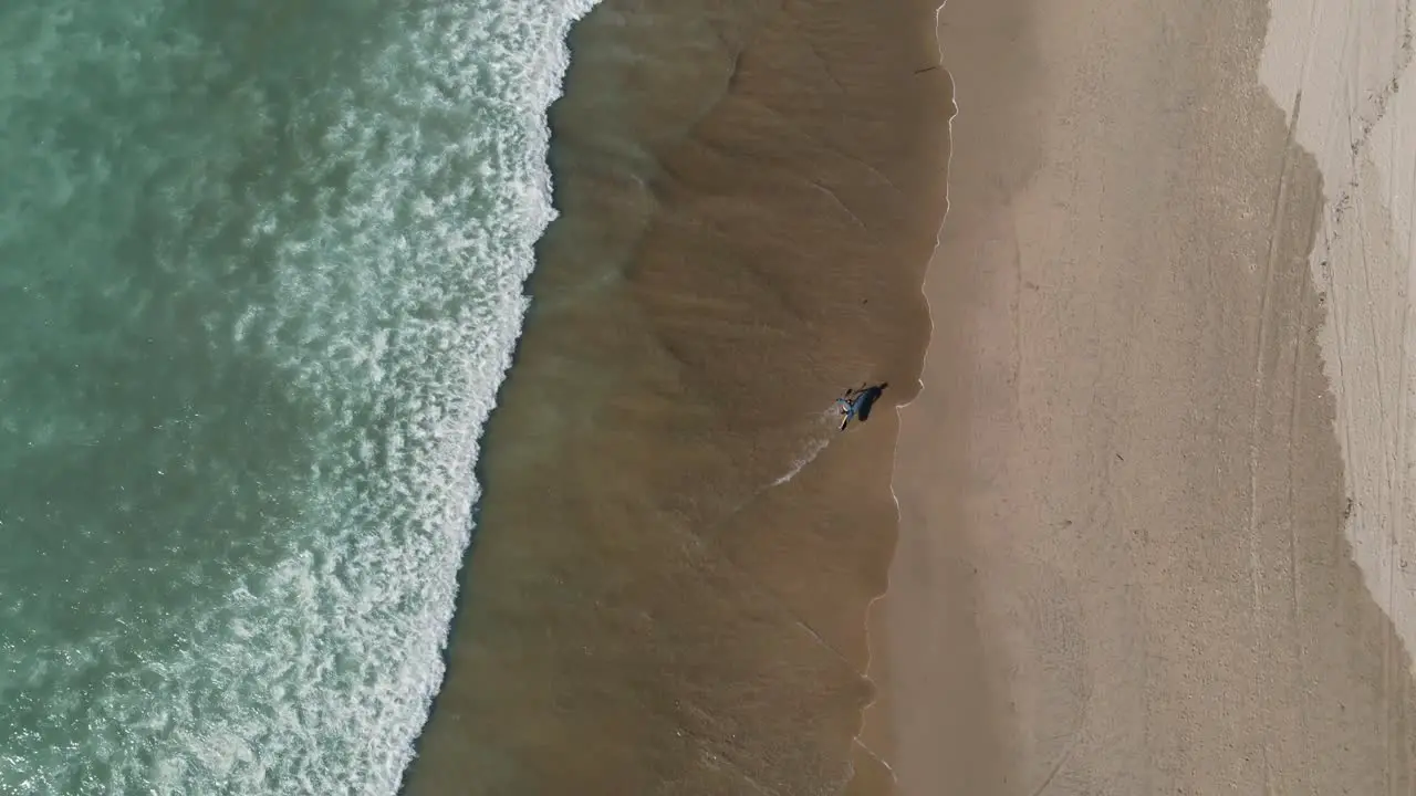 Person running on the shore close to the sea