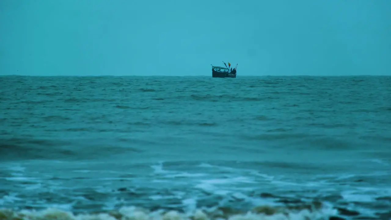 Fishing Trawler Boat out to Sea with Waves Crashing in the Foreground and the Wind Picking Up Bangladesh